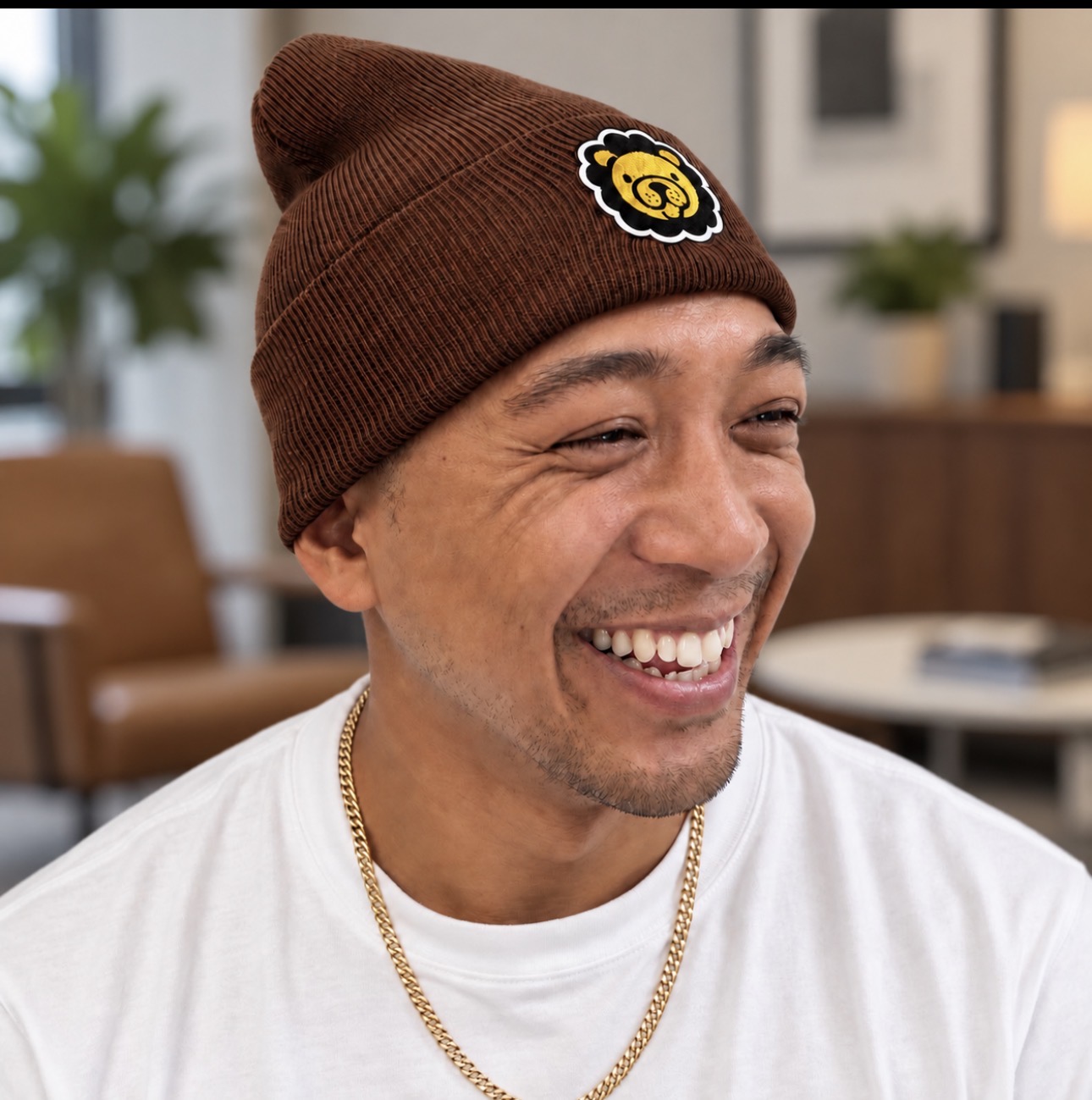 Brown beanie with a yellow lion patch